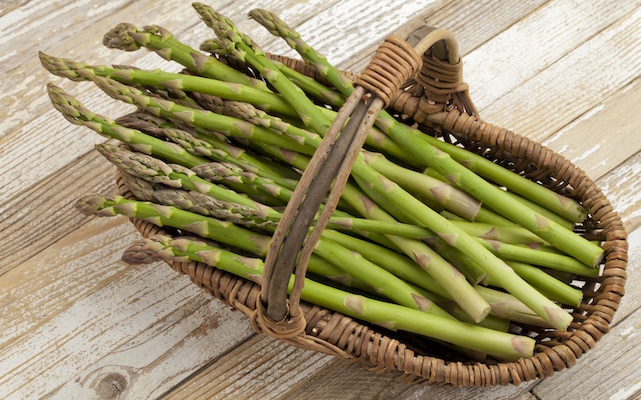 green asparagus in wicker basket